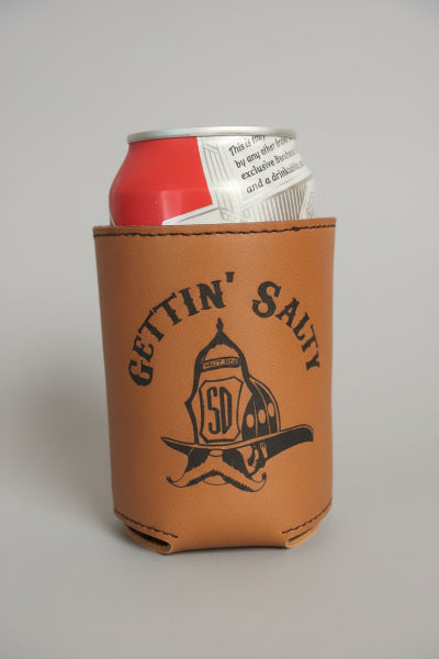 Can in a brown leather sleeve with 'Gettin' Salty' branding on a wooden bar surface. alternate view