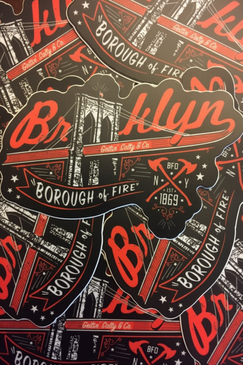 Stack of 'Borough of Fire' Brooklyn stickers with red and black design.