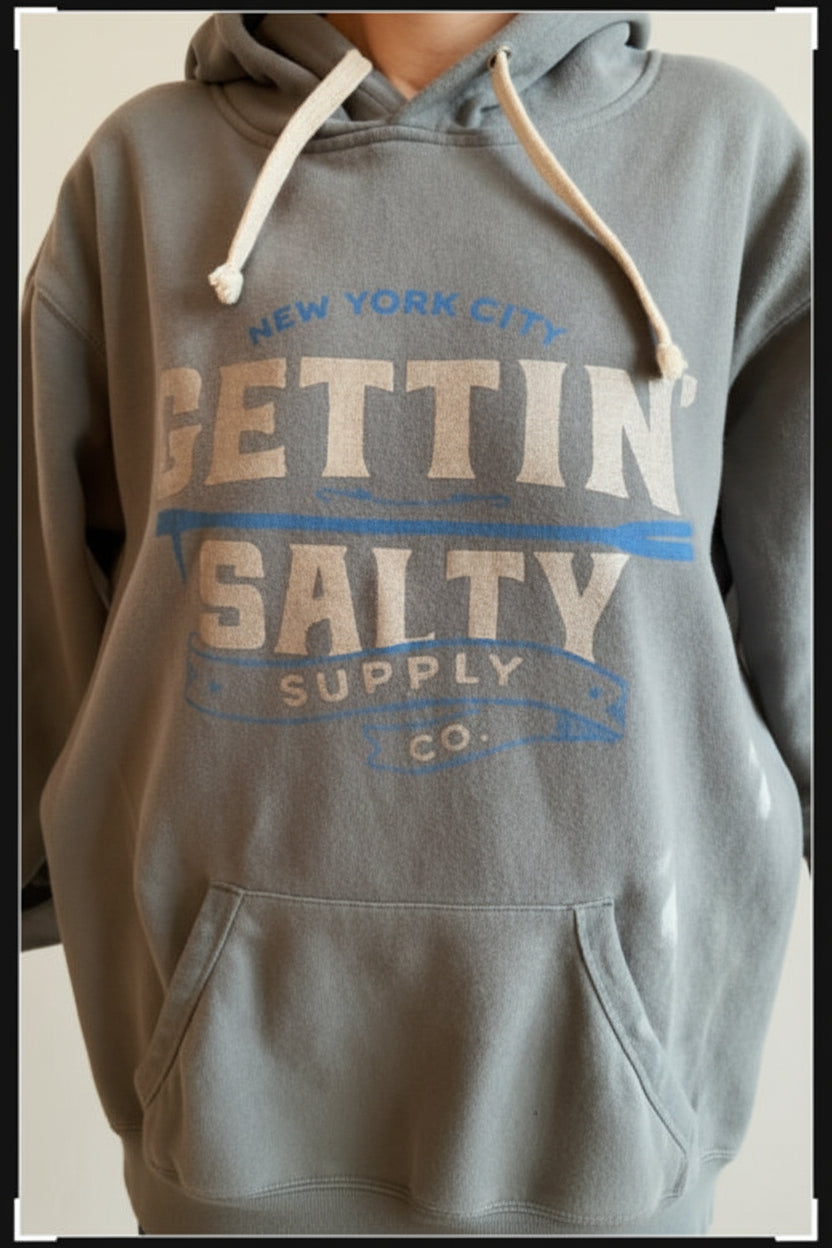 Gray hoodie with text design on a neutral background