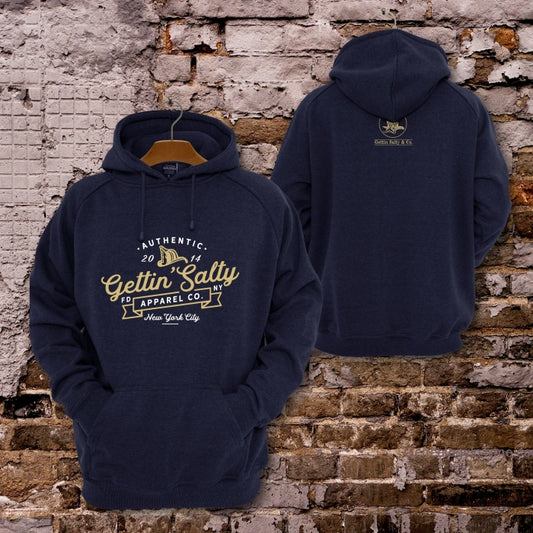 Navy blue hoodie with 'Gettin Salty' branding on a brick wall background alternate view