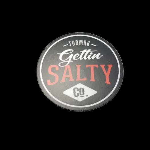 Round sticker with 'Gettin Salty' text on a black textured surface alternate view