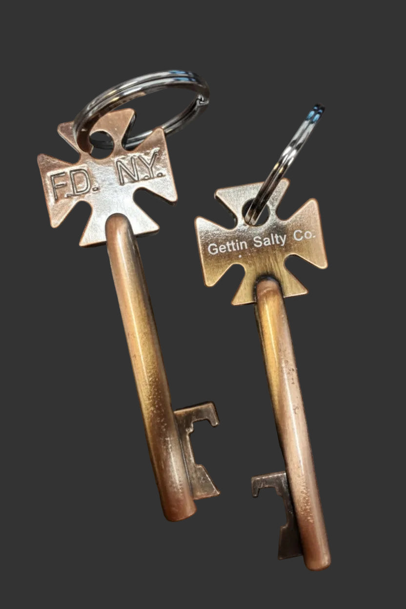 Two vintage-style box keys with metal tags on a dark surface