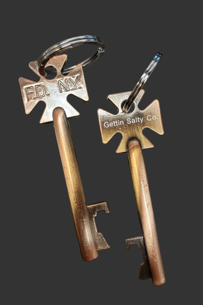 Two vintage-style box keys with metal tags on a dark surface