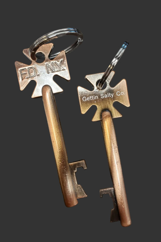 Two vintage-style box keys with metal tags on a dark surface