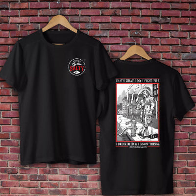 Black t-shirt with graphic design on a brick wall background