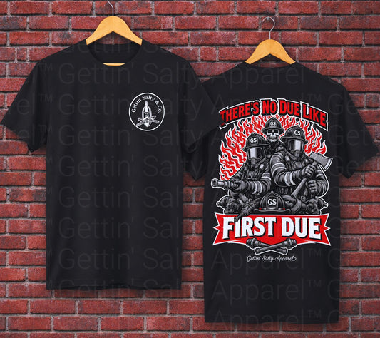 Two black t-shirts with 'First Due' graphic design on a brick wall background.