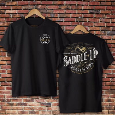 Black t-shirt with graphic design on a brick wall background