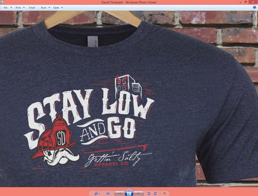 Navy blue sweatshirt with 'Stay Low and Go' graphic design on a brick wall background alternate view