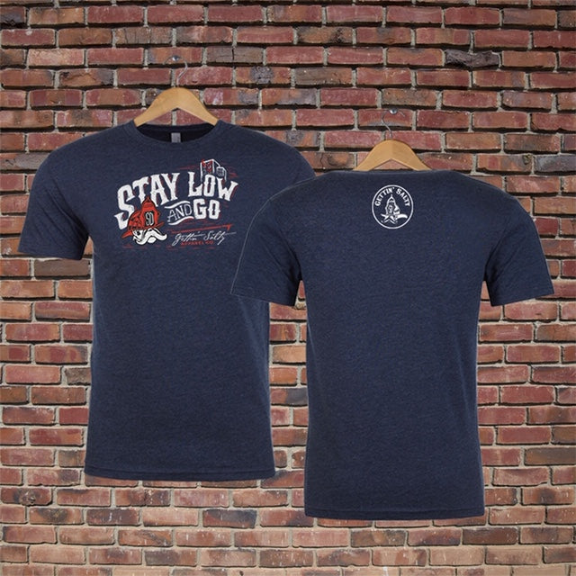 Navy blue t-shirt with text and graphics on a brick wall background