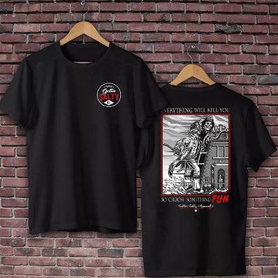 Black t-shirt with graphic design on a brick wall background