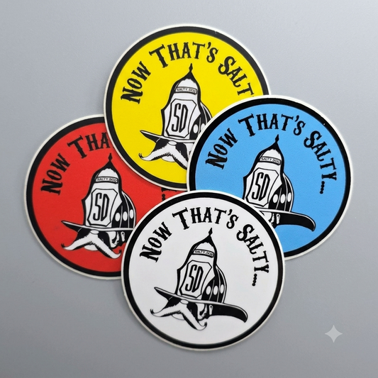 Four round stickers with the phrase 'NOW THAT'S SALTY' helmet illustration, shown in red, yellow, blue, and white on a gray background.