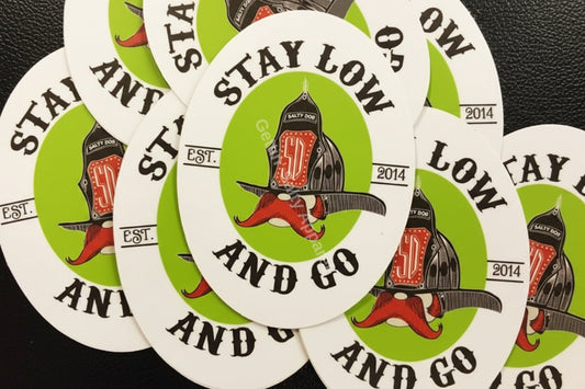 Circular stickers with 'Stay Low and Go' design featuring a red salty handlebar mustache and helmet