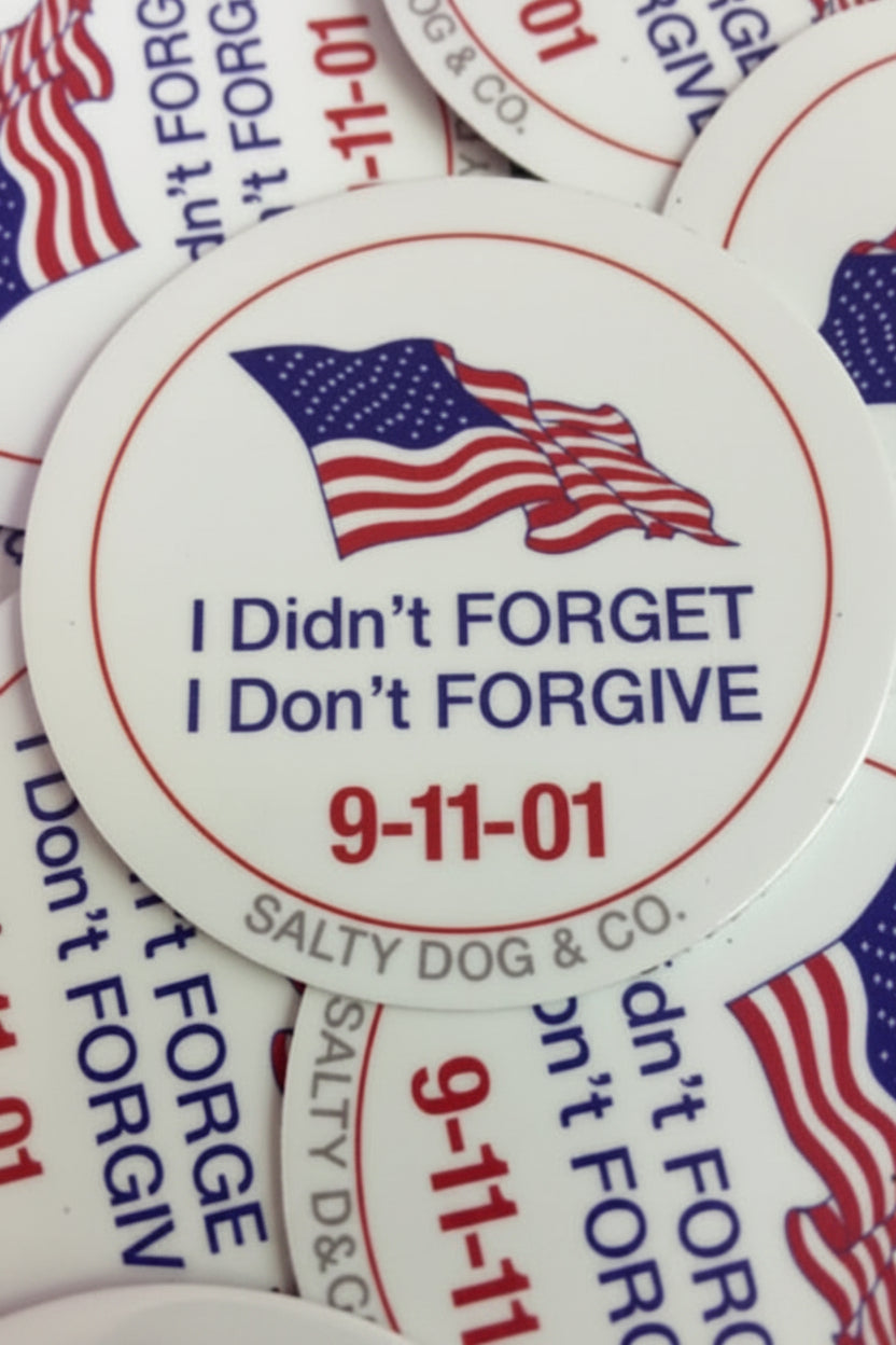 Stickers with American flag, text 'I Didn't Forget, I Don't Forgive' and '9-11-01' on a white background.