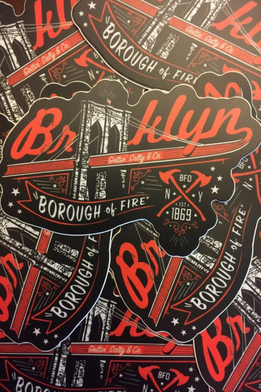 Stack of 'Borough of Fire' Brooklyn stickers with red and black design.