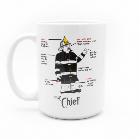 A white ceramic coffee mug featuring a humorous cartoon illustration of a firefighter labeled 'The Chief' with handwritten-style annotations.